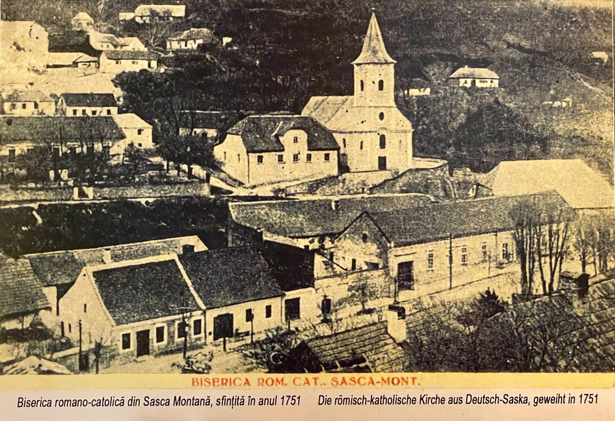 Carte poștală veche cu biserica romano-catolică din Sasca Montană, sfințită în 1751, văzută de pe deal peste acoperișurile satului