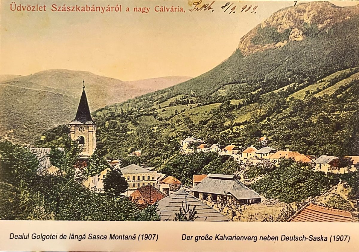 Carte poștală din 1907 cu Sasca privită dinspre Dealul Golgotei: turnul bisericii în prim-plan, casele risipite pe vale și creasta calcaroasă deasupra
